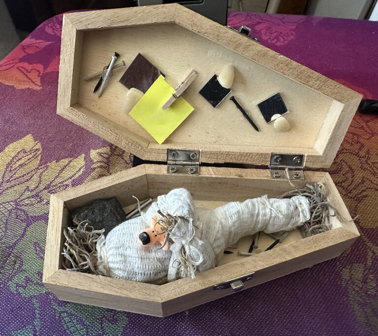 Open wooden box prepared for a combination binding and mirror box ritual